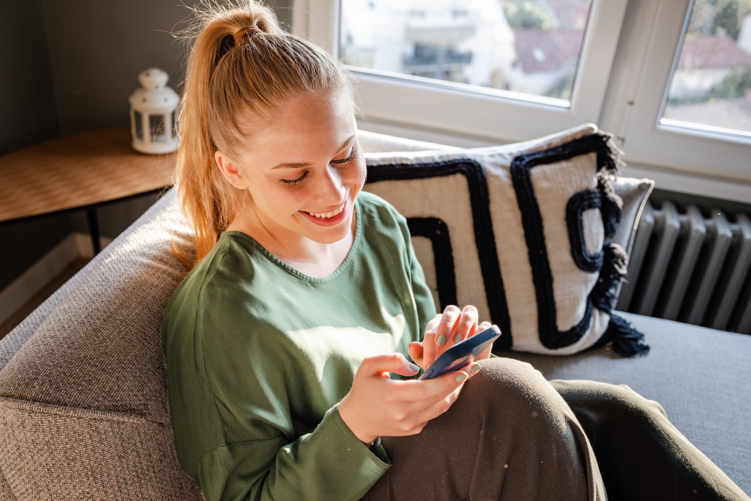 Young woman scrolling through online content on the phone